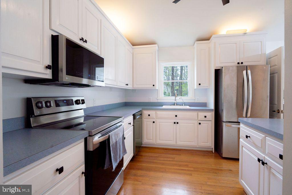 89 Club View Drive Lancaster, VA 22503 - Photo 10 of 25 a kitchen with stainless steel appliances a stove a sink and a refrigerator