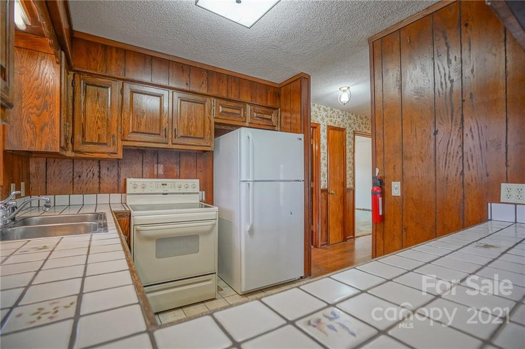 640 Coley Road Salisbury, NC 28146 - Photo 27 of 43 a kitchen with stainless steel appliances granite countertop a refrigerator and a stove