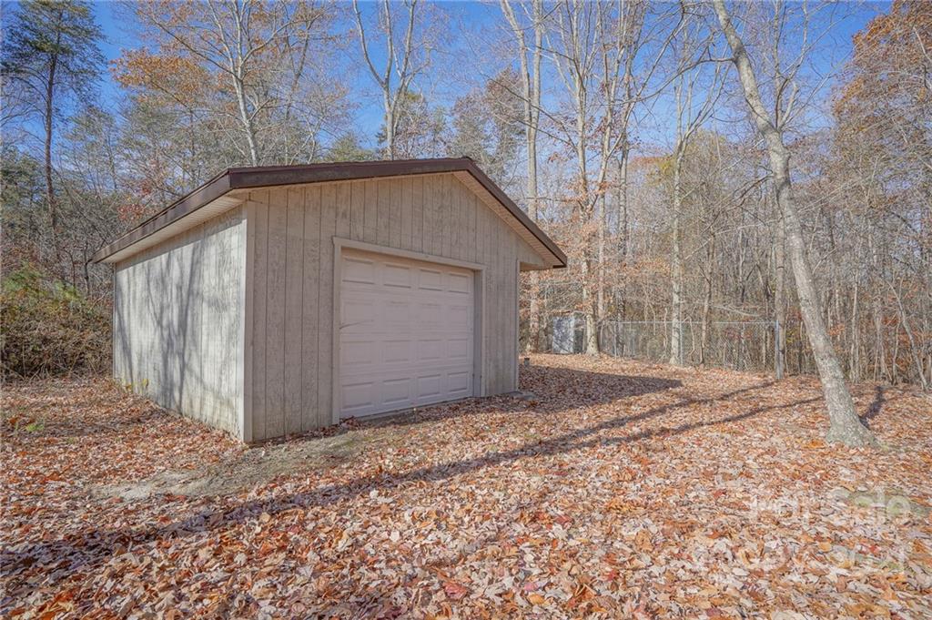 640 Coley Road Salisbury, NC 28146 - Photo 35 of 43 a view of backyard with large trees and wooden fence