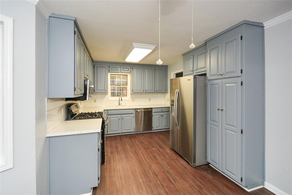 1413 Reed Lane Woodstock, GA 30189 - Photo 13 of 68 a kitchen with a refrigerator sink and cabinets