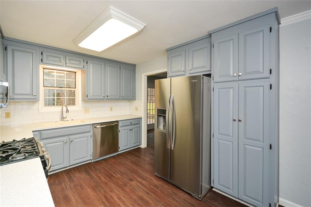 1413 Reed Lane Woodstock, GA 30189 - Photo 15 of 68 a kitchen with stainless steel appliances a refrigerator sink and cabinets
