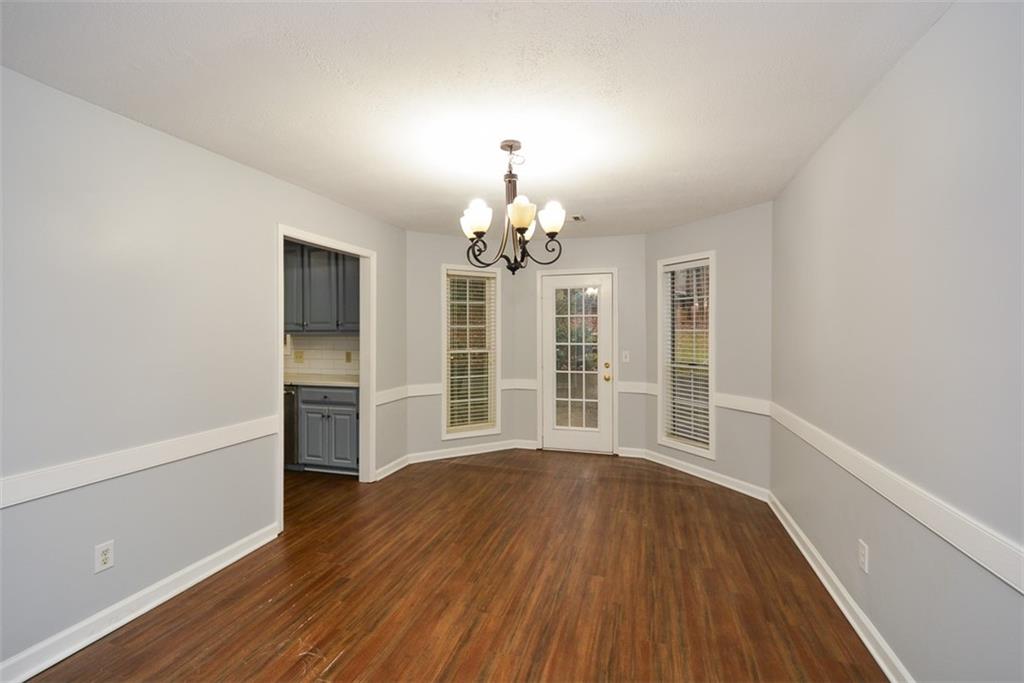 1413 Reed Lane Woodstock, GA 30189 - Photo 19 of 68 a view of an empty room with wooden floor and a window