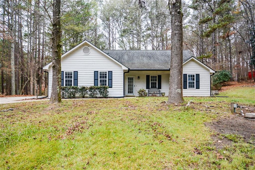 1413 Reed Lane Woodstock, GA 30189 - Photo 2 of 68 a front view of a house with a yard and trees