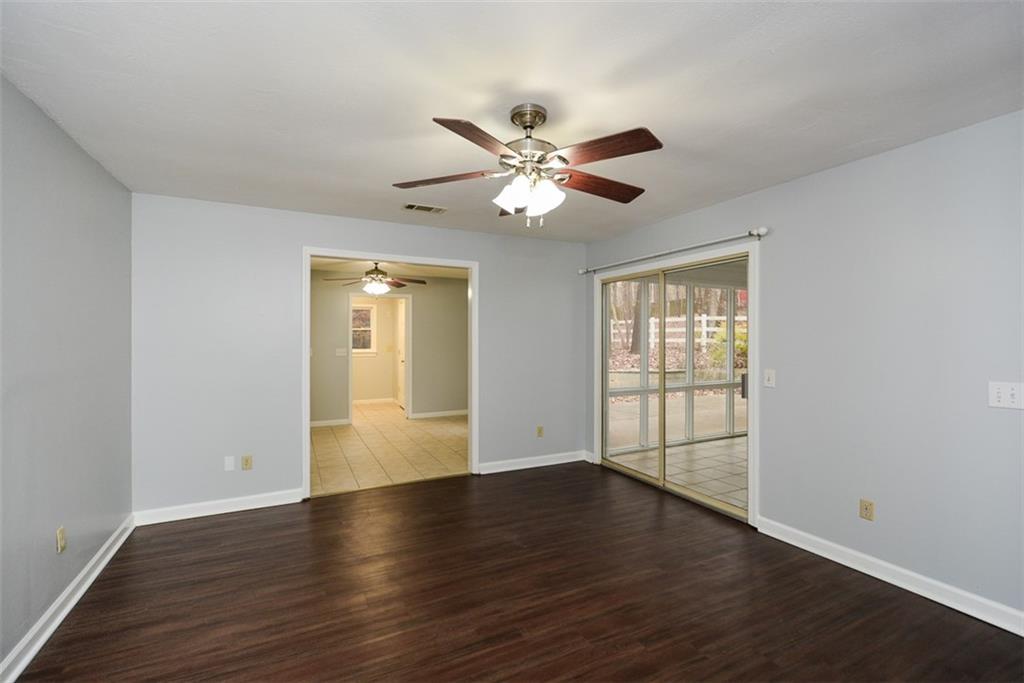 1413 Reed Lane Woodstock, GA 30189 - Photo 25 of 68 a view of an empty room with wooden floor and a window