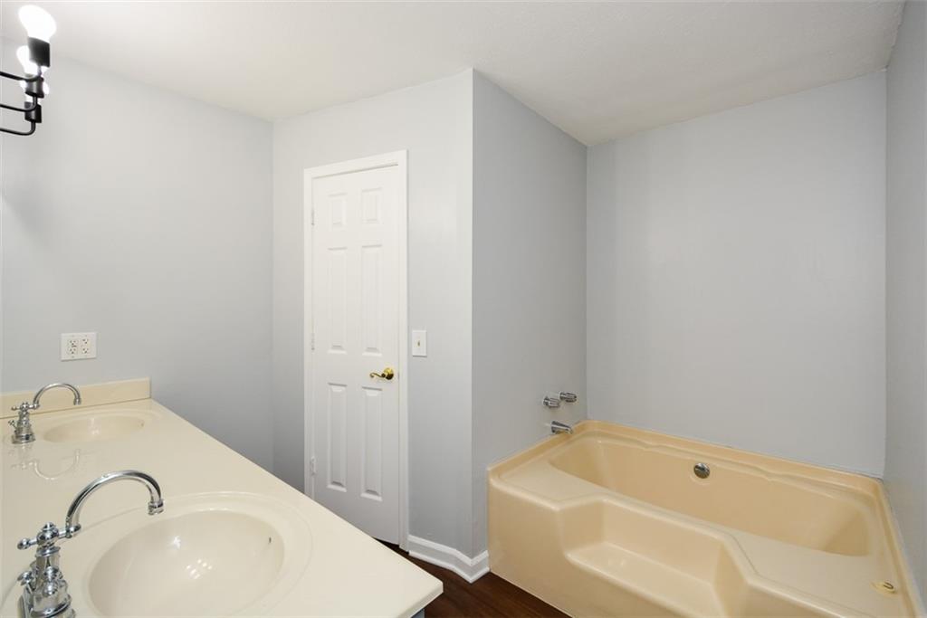 1413 Reed Lane Woodstock, GA 30189 - Photo 30 of 68 a bathroom with a sink and a tub