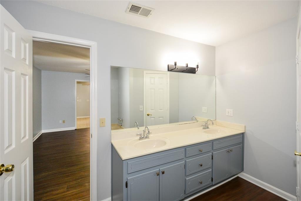 1413 Reed Lane Woodstock, GA 30189 - Photo 32 of 68 a bathroom with a double vanity sink and mirror