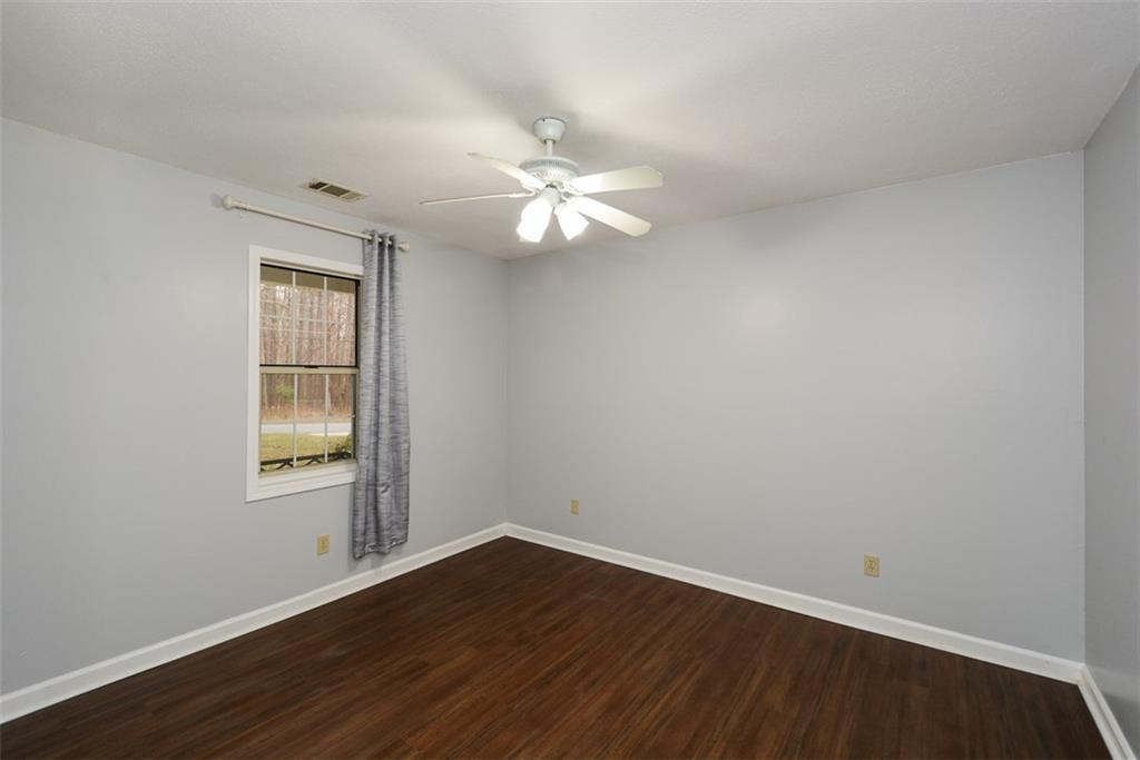 1413 Reed Lane Woodstock, GA 30189 - Photo 35 of 68 wooden floor in an empty room with a window
