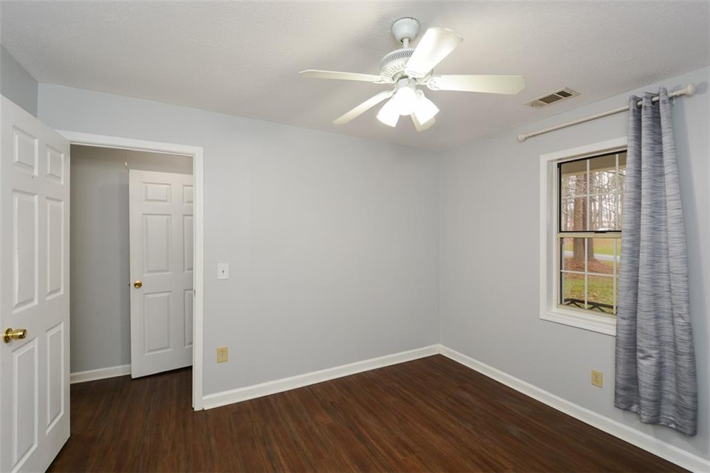 1413 Reed Lane Woodstock, GA 30189 - Photo 36 of 68 a view of an empty room with wooden floor and a window