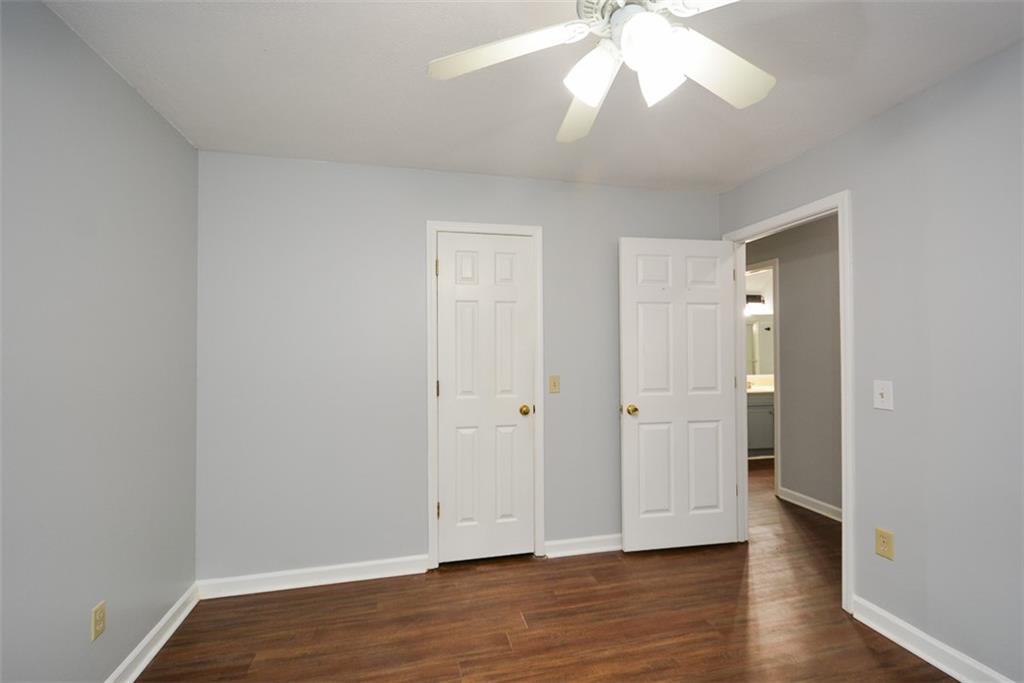 1413 Reed Lane Woodstock, GA 30189 - Photo 37 of 68 an empty room with wooden floor and a ceiling fan