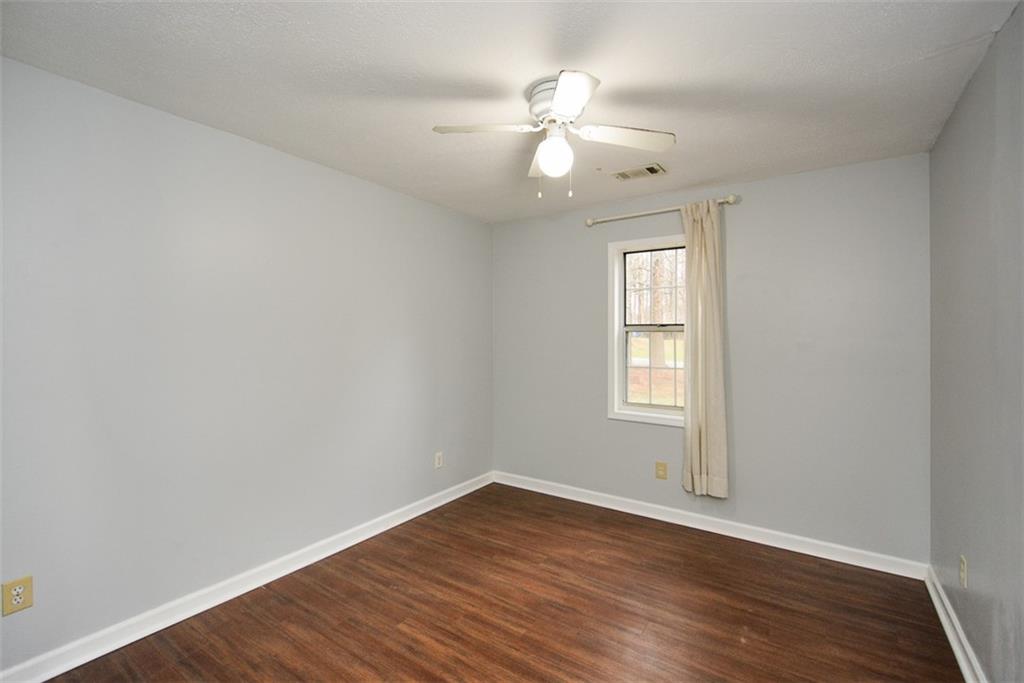 1413 Reed Lane Woodstock, GA 30189 - Photo 38 of 68 a view of an empty room with wooden floor and a window