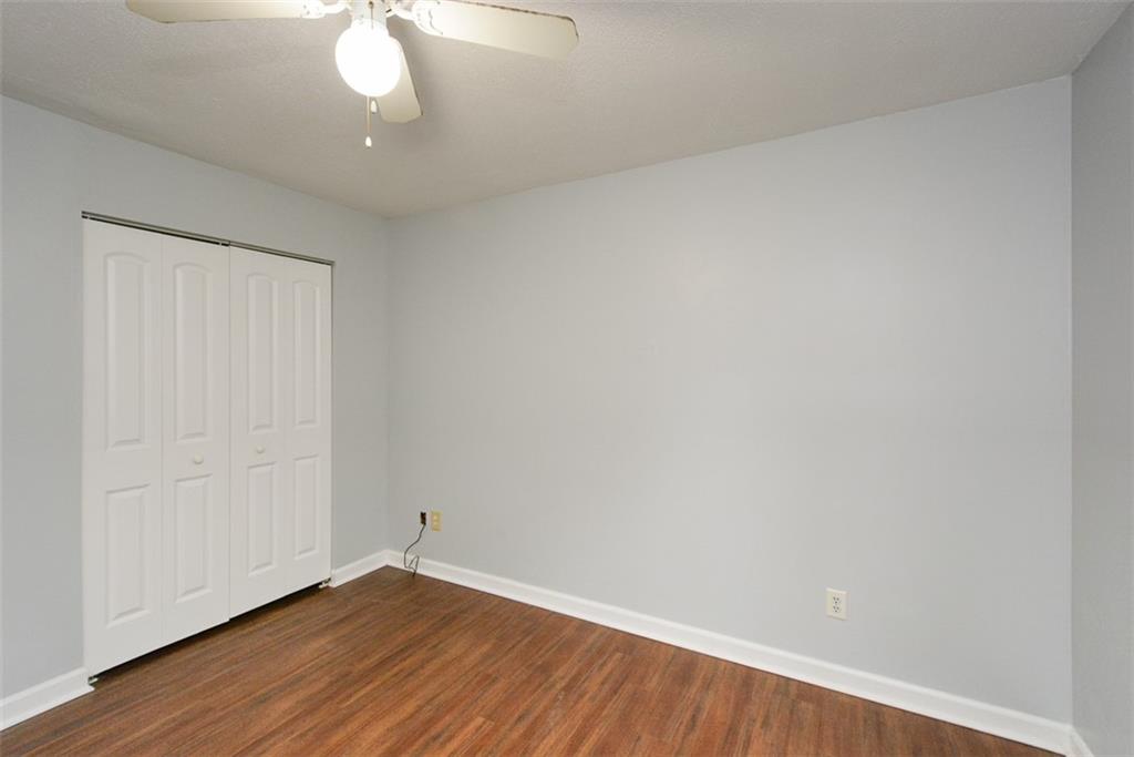 1413 Reed Lane Woodstock, GA 30189 - Photo 39 of 68 an empty room with wooden floor and windows
