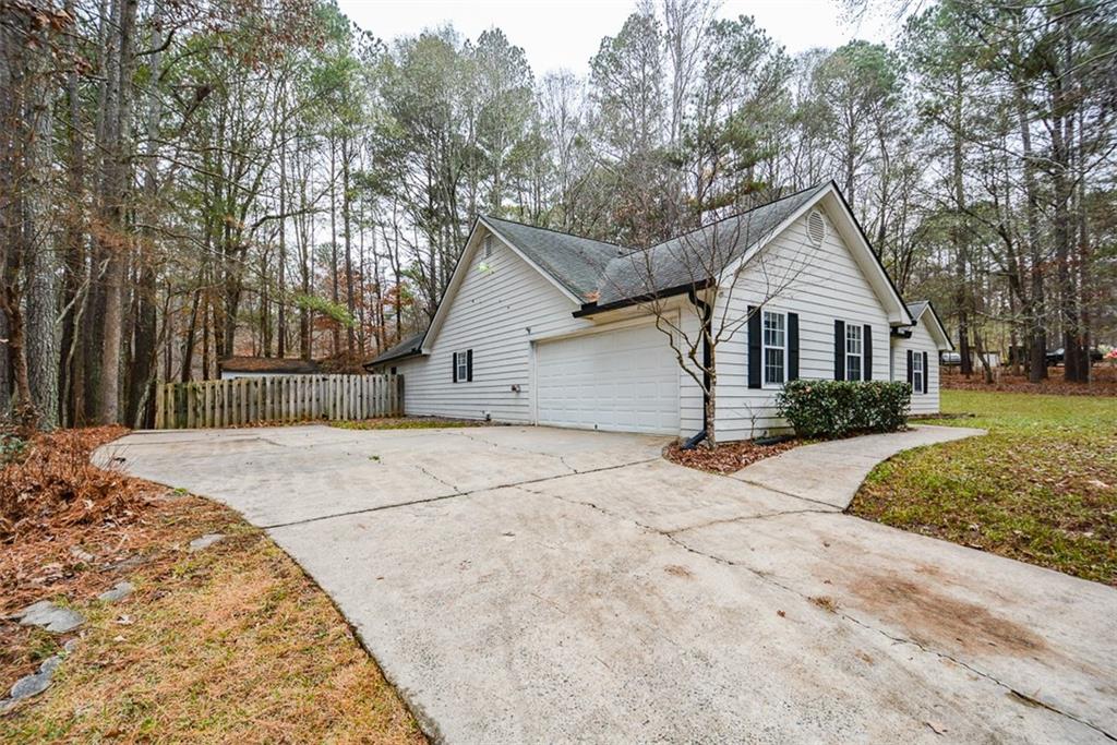 1413 Reed Lane Woodstock, GA 30189 - Photo 4 of 68 a view of garage yard and tree