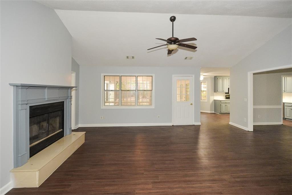 1413 Reed Lane Woodstock, GA 30189 - Photo 8 of 68 a view of an empty room with wooden floor fireplace and a window