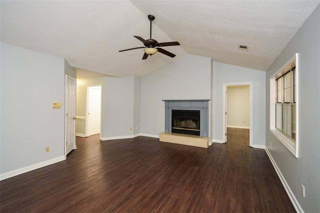 1413 Reed Lane Woodstock, GA 30189 - Photo 9 of 68 a view of empty room with wooden floor and fireplace