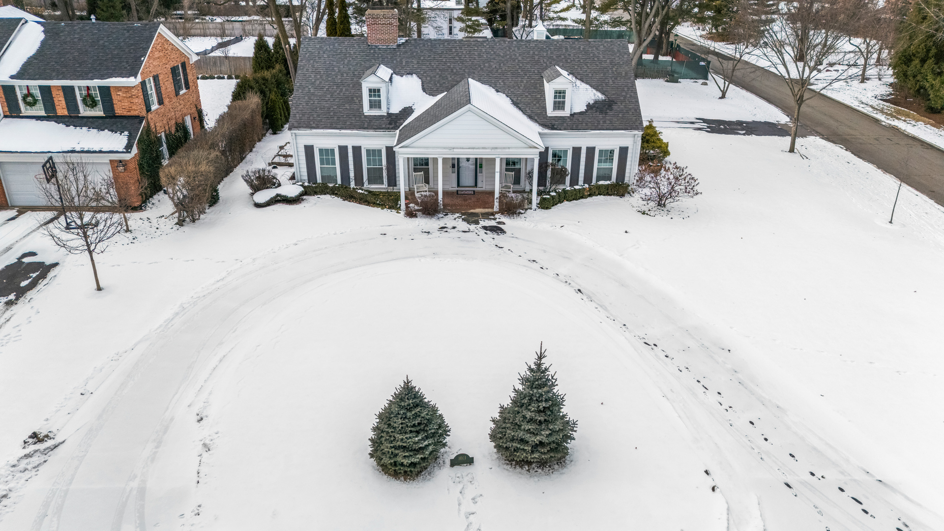 1011 Mohawk Road Wilmette, IL 60091 - Photo 5 of 11 an aerial view of a house with a yard covered with snow in the background