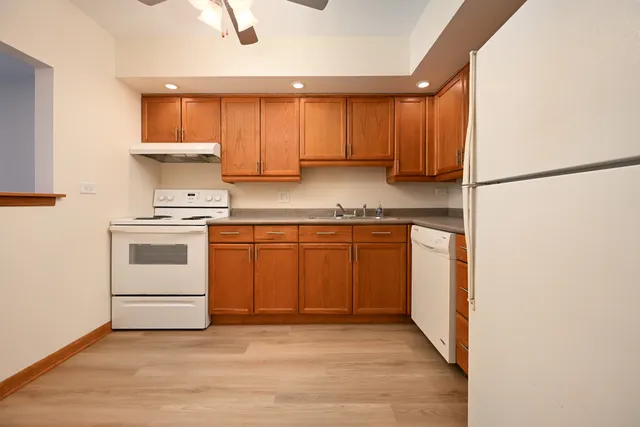 a kitchen with a stove top oven sink and cabinets