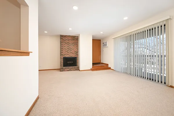 a view of an empty room with a fireplace
