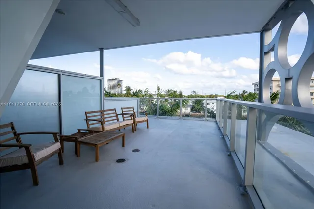 a balcony with wooden floor and outdoor seating