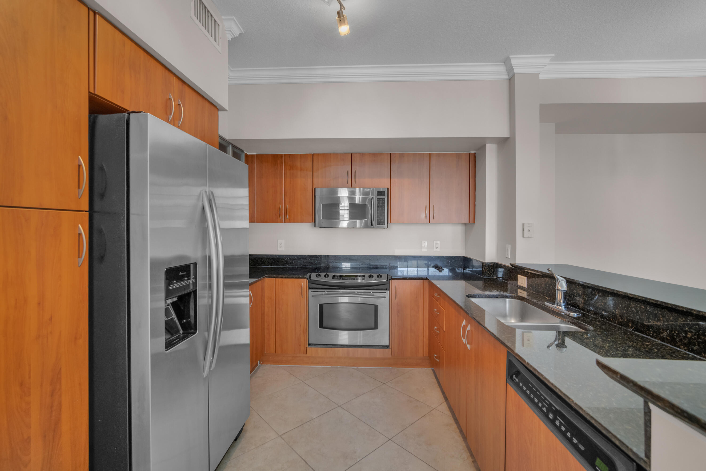 233 South Federal Highway, Unit 603 Boca Raton, FL 33432 - Photo 8 of 18 a kitchen with stainless steel appliances granite countertop a stove and a refrigerator