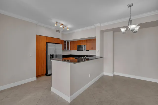 a view of kitchen with stainless steel appliances granite countertop cabinets and wooden floor