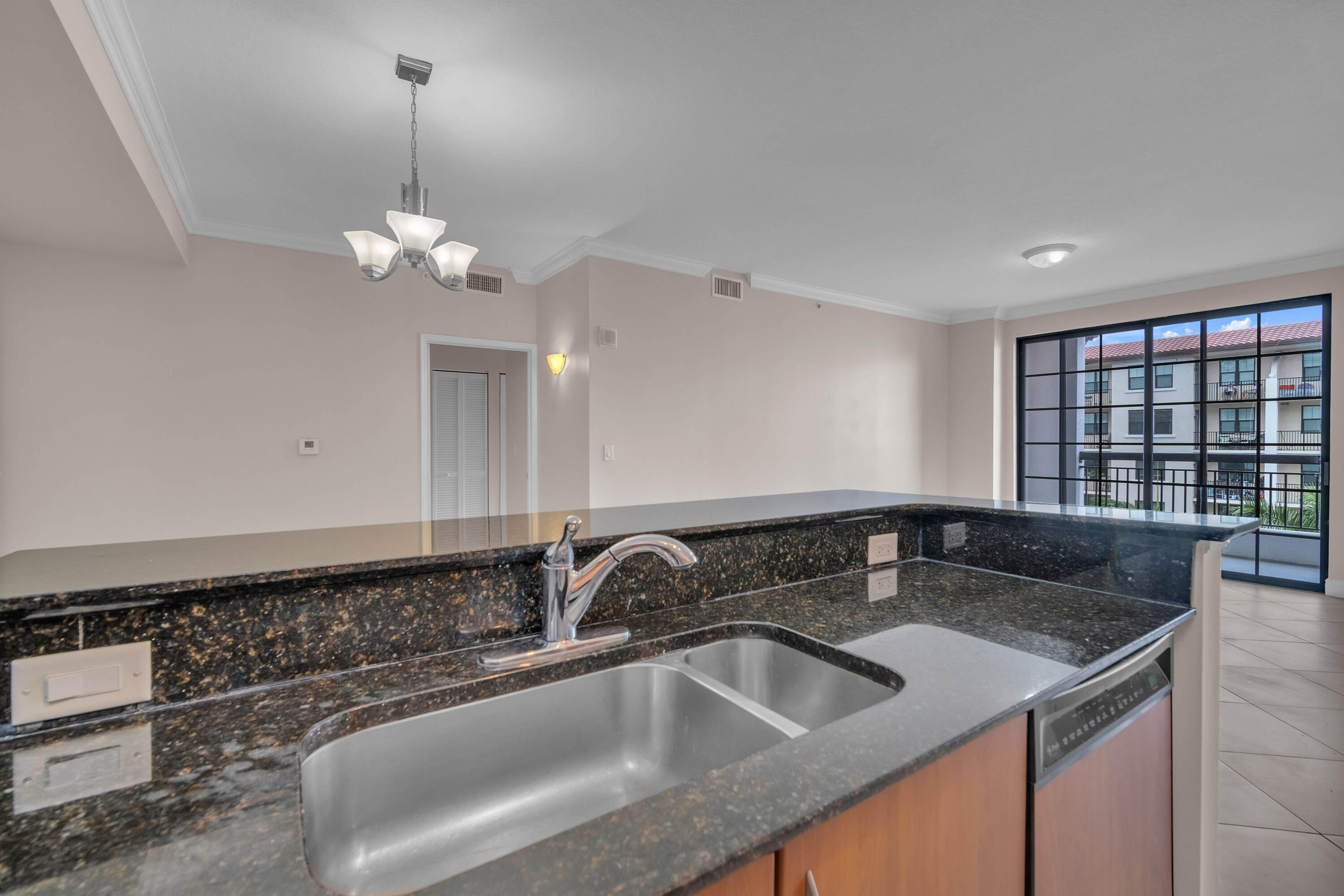 233 South Federal Highway, Unit 603 Boca Raton, FL 33432 - Photo 10 of 18 a kitchen with a sink and chandelier