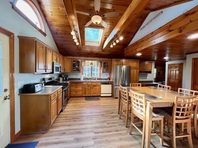 144 Walnut Plain Road Rochester, MA 02770 - Photo 7 of 34 a kitchen with stainless steel appliances kitchen island granite countertop a large kitchen island a stove a table and chairs
