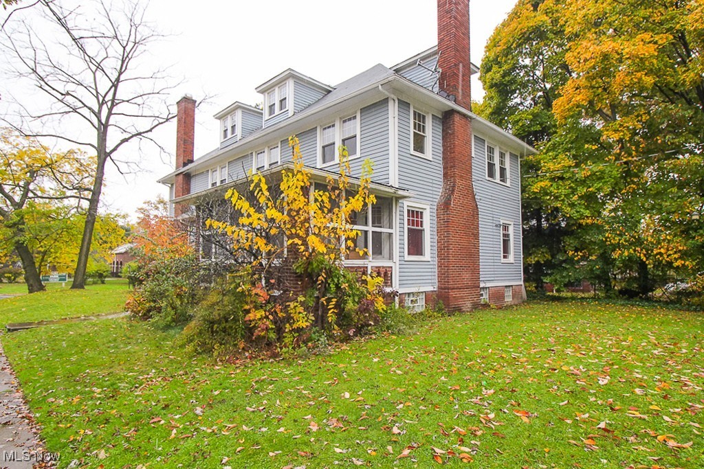 3085 Somerton Road Cleveland, OH 44118 - Photo 2 of 16 View of property exterior with a yard, a chimney, and a sunroom