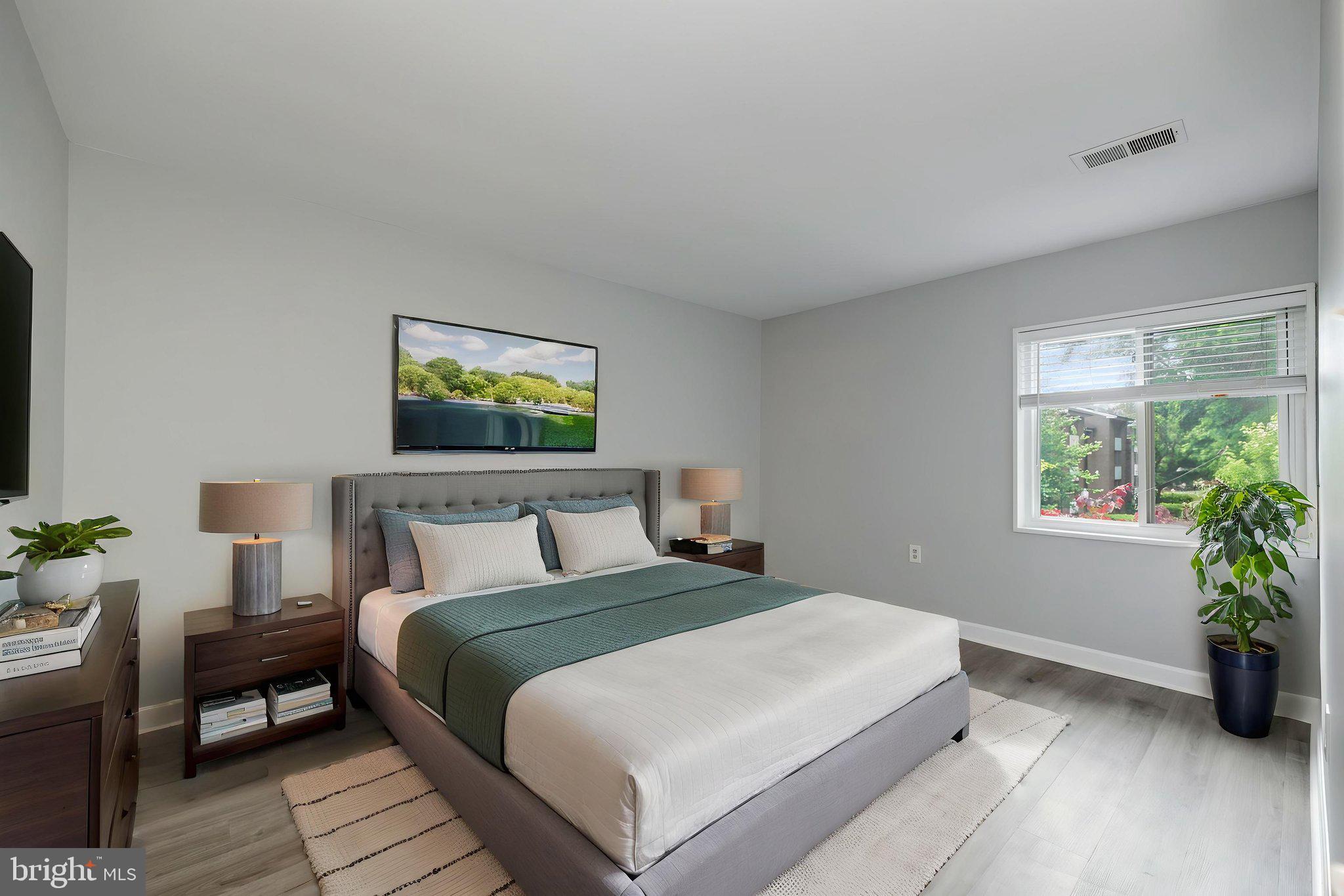 1443 Northgate Square, Unit 22B Reston, VA 20190 - Photo 18 of 42 a bedroom with a bed and a potted plant