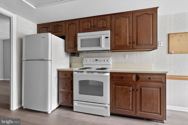 a kitchen with cabinets and white appliances