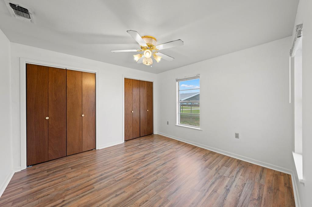133 Myrtle Avenue Harper, TX 78631 - Photo 12 of 25 a view of an empty room with window and wooden floor