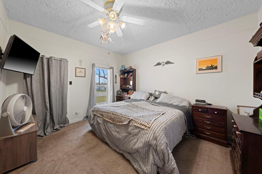133 Myrtle Avenue Harper, TX 78631 - Photo 10 of 25 a spacious bedroom with a bed and a flat screen tv