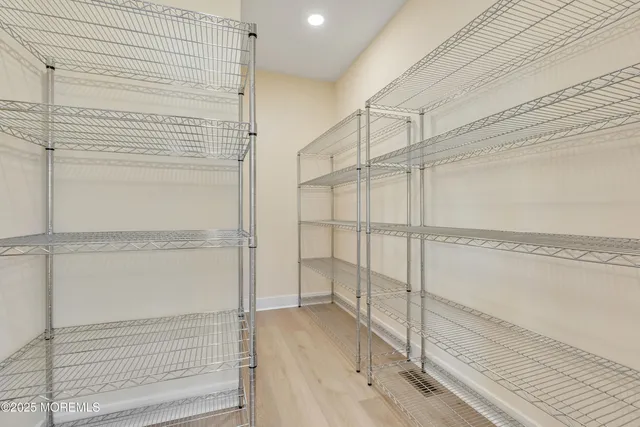 a large kitchen with a sink and dishwasher a stove top oven with wooden floor