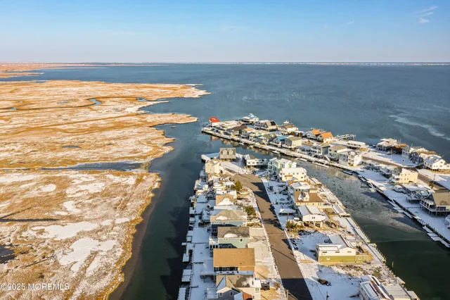 a kitchen with granite countertop a sink a counter space appliances and cabinets