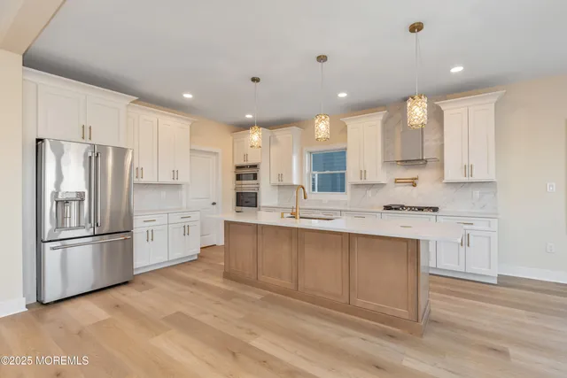 a kitchen with granite countertop a stove a sink cabinets and a window