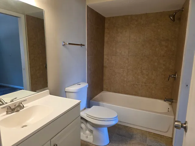 a bathroom with a sink a toilet and a bathtub