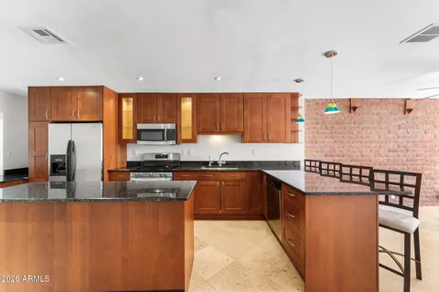 a kitchen with stainless steel appliances granite countertop a stove and a refrigerator