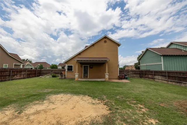 a view of a house with a yard and sitting area