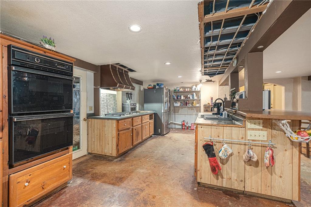 880 Golf Course Road Demorest, GA 30535 - Photo 12 of 37 a kitchen with stainless steel appliances kitchen island granite countertop a stove and a microwave with cabinets