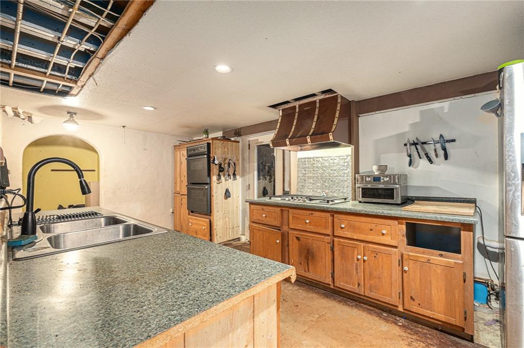 880 Golf Course Road Demorest, GA 30535 - Photo 13 of 37 a kitchen with stainless steel appliances granite countertop a sink a stove and cabinets