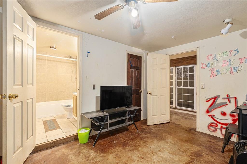 880 Golf Course Road Demorest, GA 30535 - Photo 18 of 37 a living room with projector and a flat screen tv