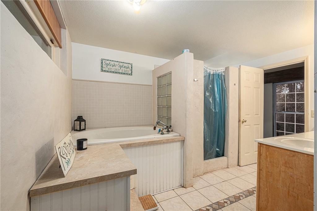 880 Golf Course Road Demorest, GA 30535 - Photo 28 of 37 a bathroom with a sink vanity and a mirror