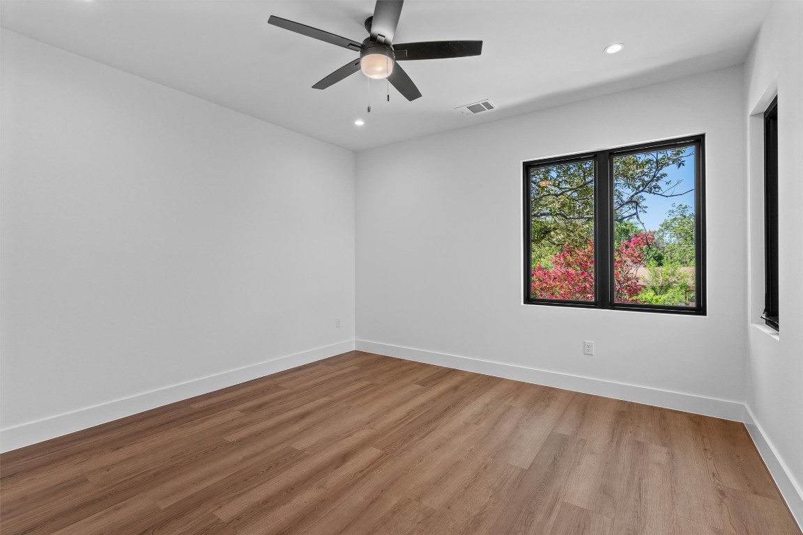 1402 Beckett Street, Unit 1B Austin, TX 78757 - Photo 12 of 32 a view of an empty room with a window and wooden floor