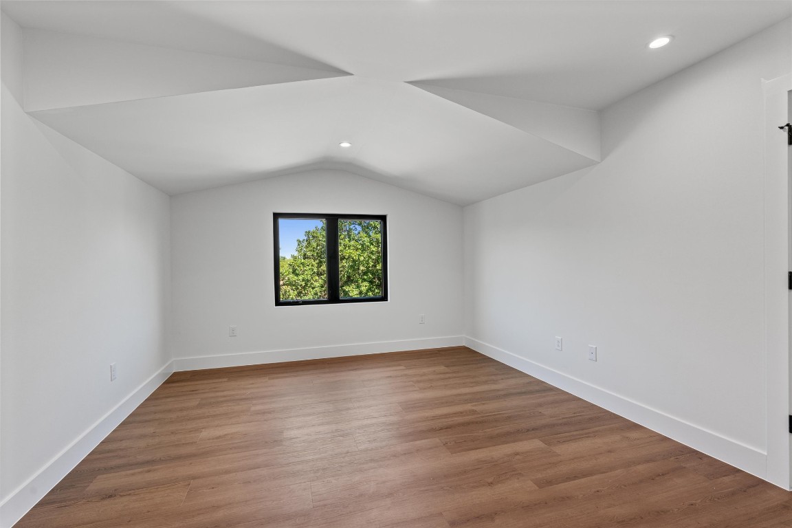 1402 Beckett Street, Unit 1B Austin, TX 78757 - Photo 23 of 32 a view of an empty room with wooden floor and a window