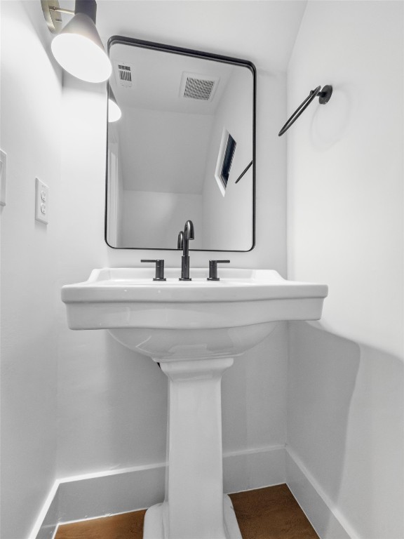 1402 Beckett Street, Unit 1B Austin, TX 78757 - Photo 26 of 32 a bathroom with a sink and a mirror