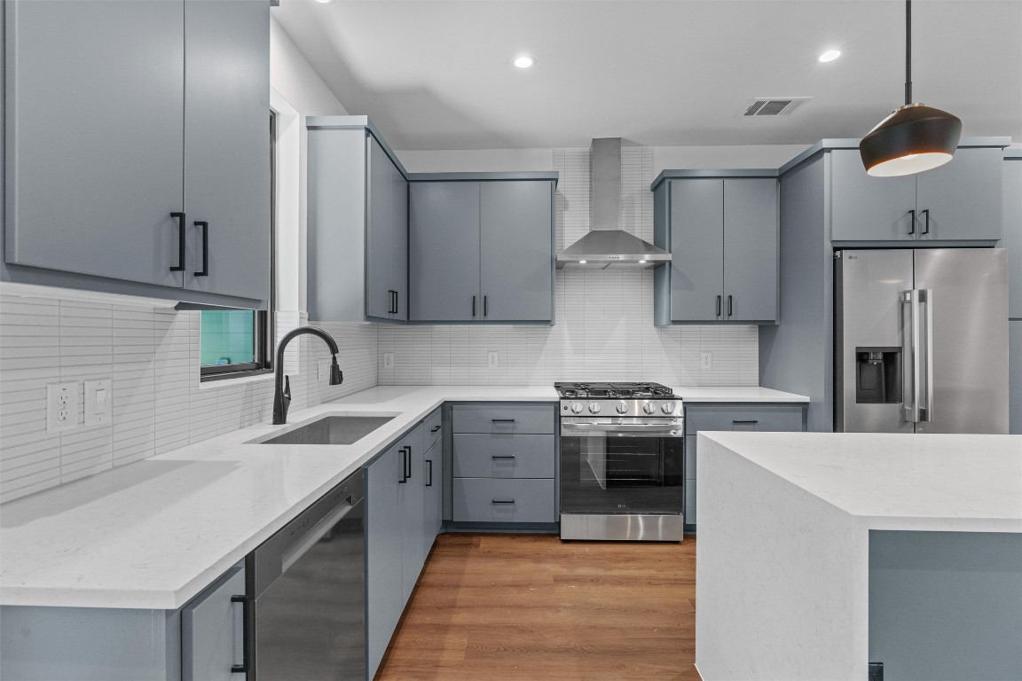 1402 Beckett Street, Unit 1B Austin, TX 78757 - Photo 4 of 32 a kitchen with stainless steel appliances granite countertop a sink stove and refrigerator