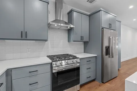 a kitchen with a sink cabinets and stainless steel appliances