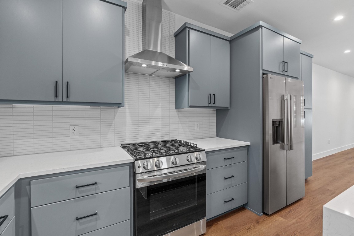 1402 Beckett Street, Unit 1B Austin, TX 78757 - Photo 6 of 32 a kitchen with stainless steel appliances white cabinets and a stove