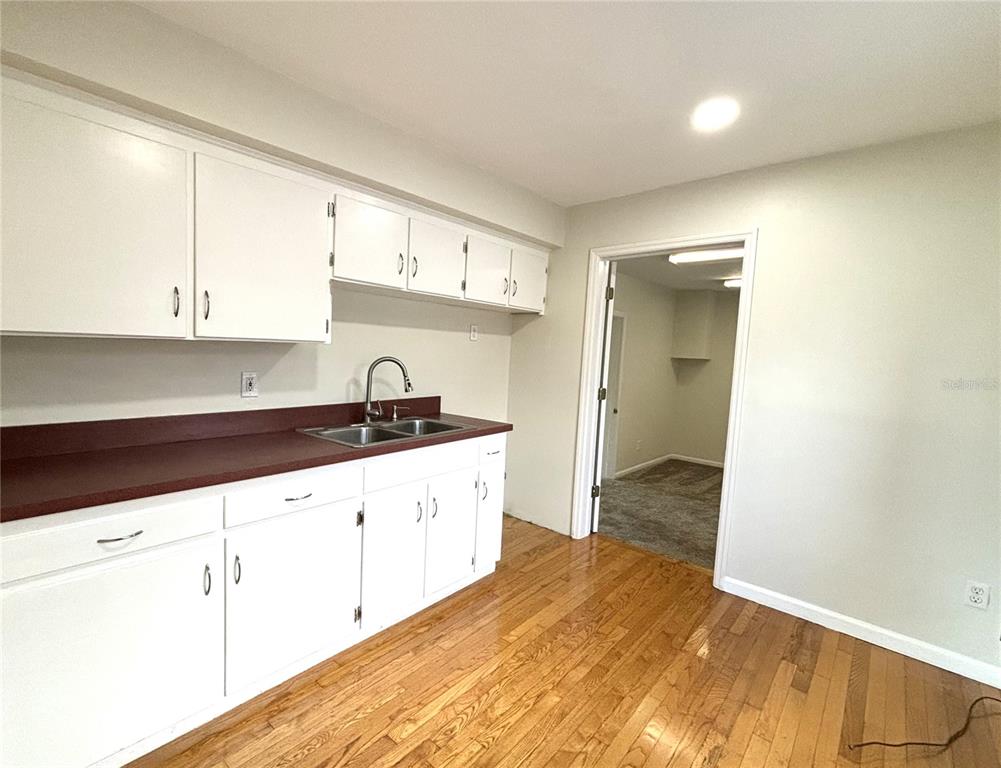 2350 26th Street North St. Petersburg, FL 33713 - Photo 11 of 18 a kitchen with granite countertop white cabinets and sink