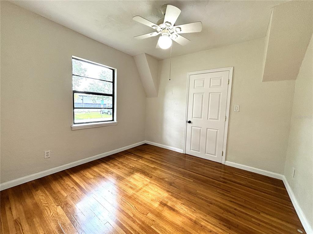 2350 26th Street North St. Petersburg, FL 33713 - Photo 10 of 18 a view of an empty room with wooden floor and a window