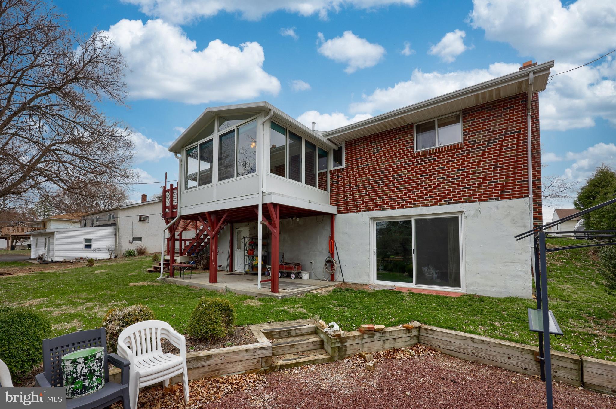 3916 Grant Street Reading, PA 19606 - Photo 12 of 39 a front view of a house with a yard table and chairs